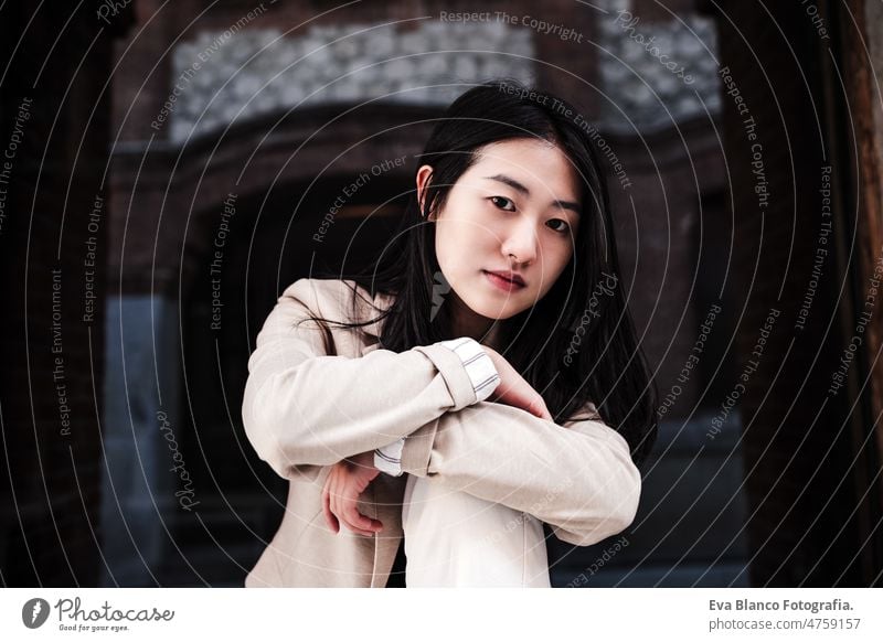 close up portrait of confident chinese woman in city leaning on wall lifestyle modern business entrepreneur asian beautiful ethnic international face attractive
