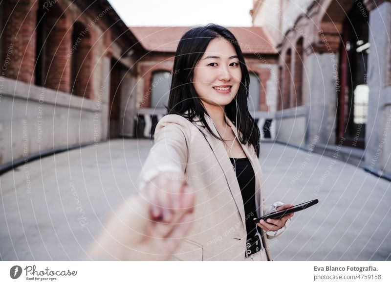 confident beautiful chinese business woman using mobile phone in city.Holding hand with friend. POV holding hand asian laptop technology cafe coffee cafeteria