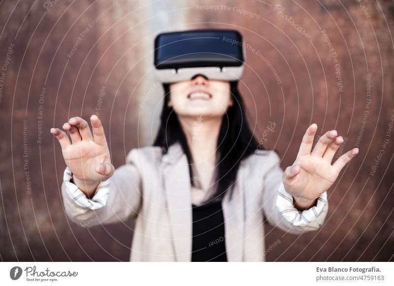 chinese Businesswoman using virtual reality headset. selective focus on hands. technology vr goggles meta verse attractive young game contraption lady smart