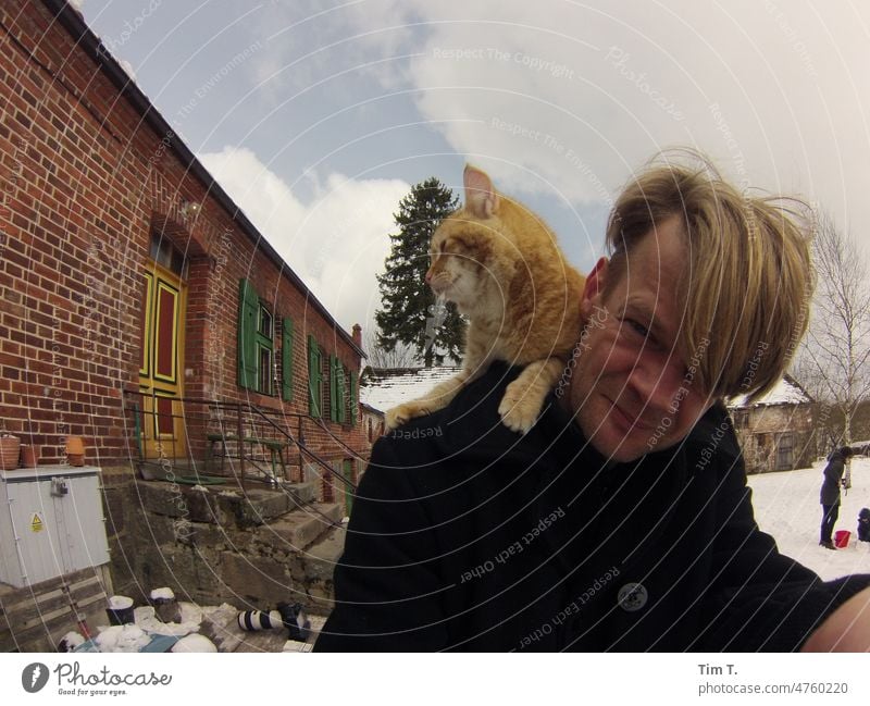 a man with a red cat on his shoulder in winter Farm Red hangover Cat Winter Poland Estate Snow Cold Pet Animal Pelt Domestic cat Animal portrait Exterior shot