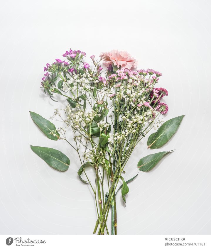Bouquet with flowers and green leaves on white background bouquet garden top view beautiful bloom blooming blossom bunch bunch of flowers garden flowers petal