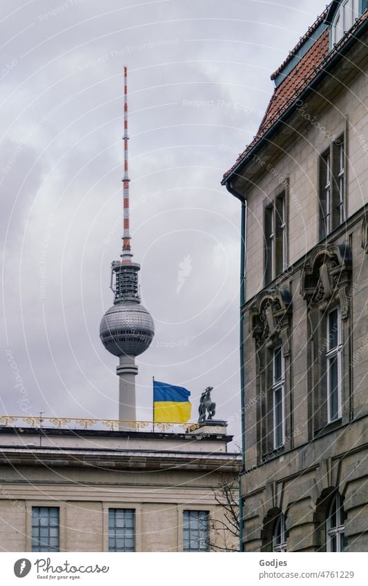 Ukrainian flag on building in front of TV tower Berlin, house front in foreground Ukraine Television tower Peace War protest Solidarity Politics and state Hope