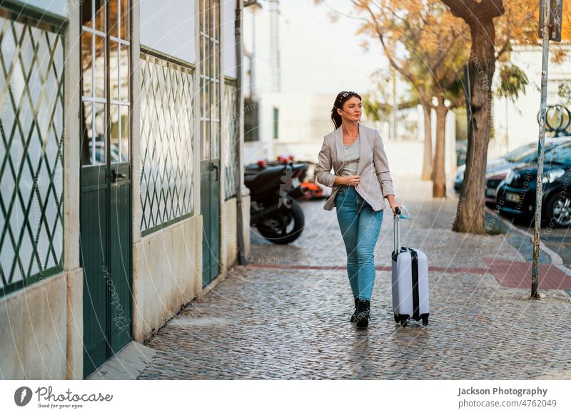 Portrait of traveling woman with luggage in the city covid-19 medical protective pandemic mask explore student businessperson adventure traveler transportation