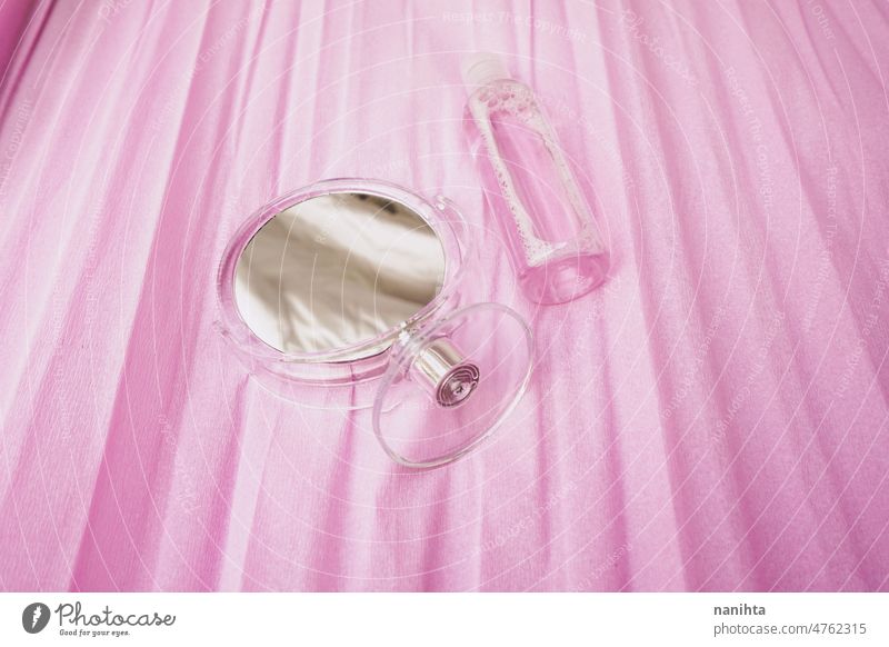 Simply and clean still life of a eco facial lotion and a beauty mirror in pink tones cosmetics femininity simple paper texture background reflection fresh