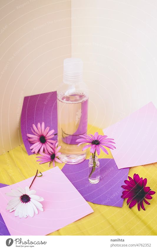 Still life of eco cosmetics with flowers in paper background design spring tiny bottle tonic lotion fragrance water springtime floral seasonal pop colorful