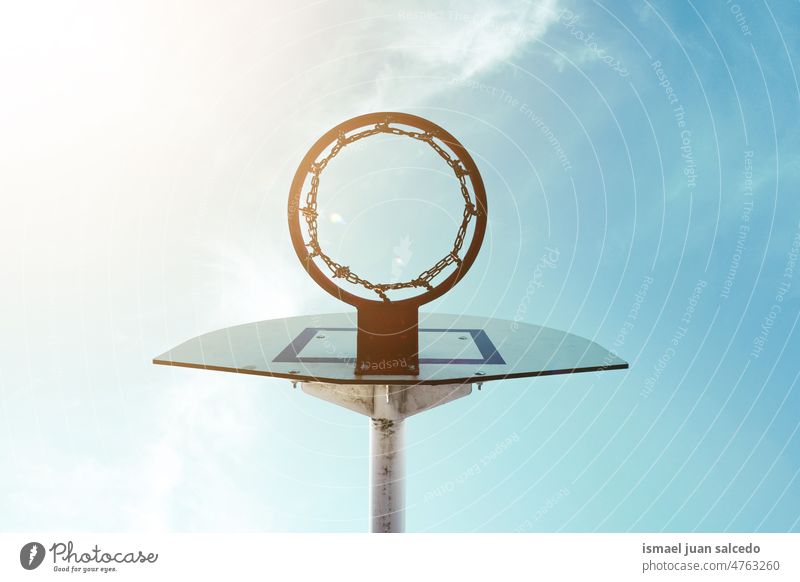 old abandoned street basket hoop basketball sky blue silhouette circle chain metallic net sport sports equipment play playing playful park playground outdoors