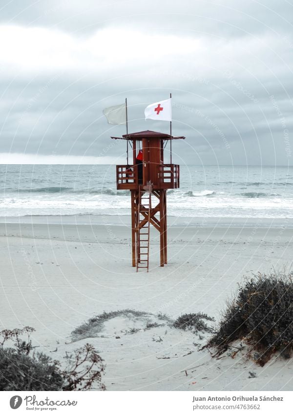 Watchtower on the beach of La Barrosa, in Chiclana de la Frontera, Cádiz province, Andalusia, Spain beach watcher watchtower man vacations la barrosa