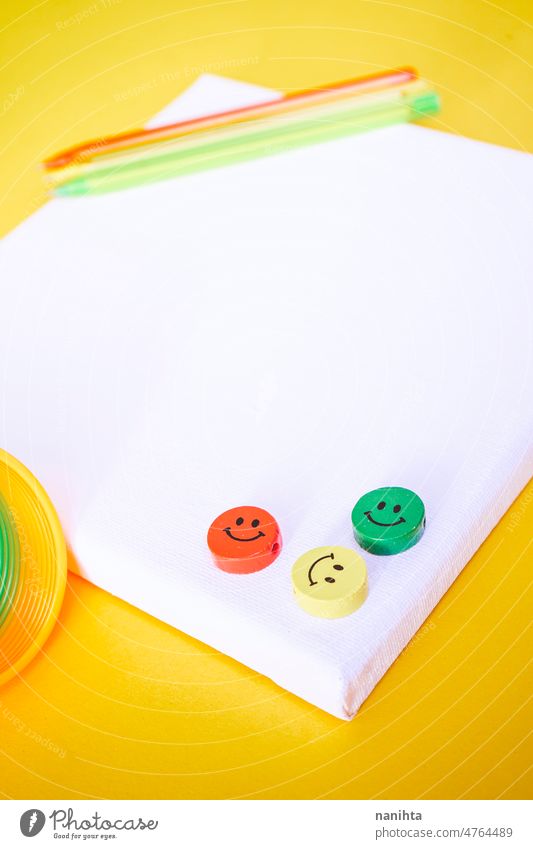 Close up of three colorful smiley faces over a white canvas mockup mock up childhood positive happiness friends attitude optimism school pen toys emoji pieces