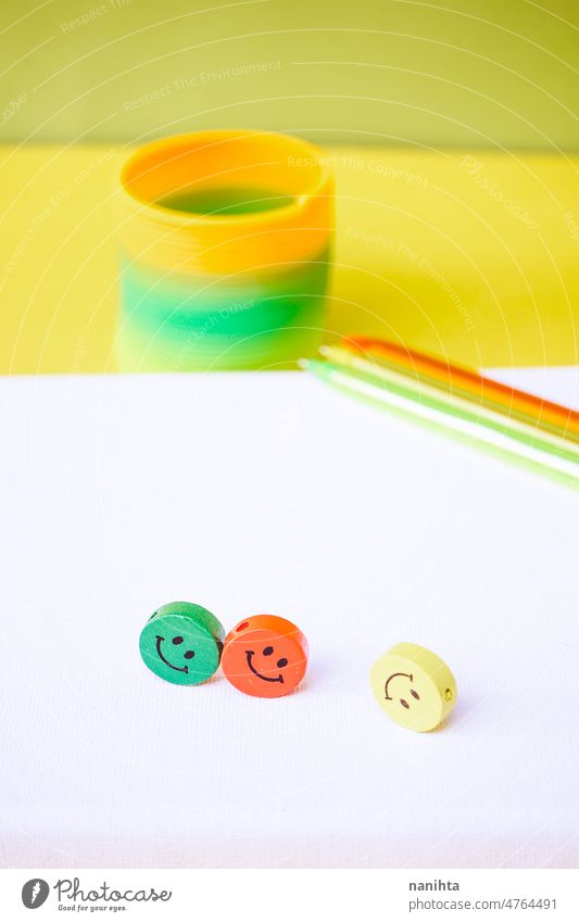 Close up of three colorful smiley faces over a white canvas mockup mock up childhood positive happiness friends attitude optimism school pen toys emoji pieces