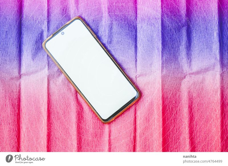 Android smartphone mockup against a colorful background smart phone android mock up white blanket screen copy space negative space intense vibrant multicolored