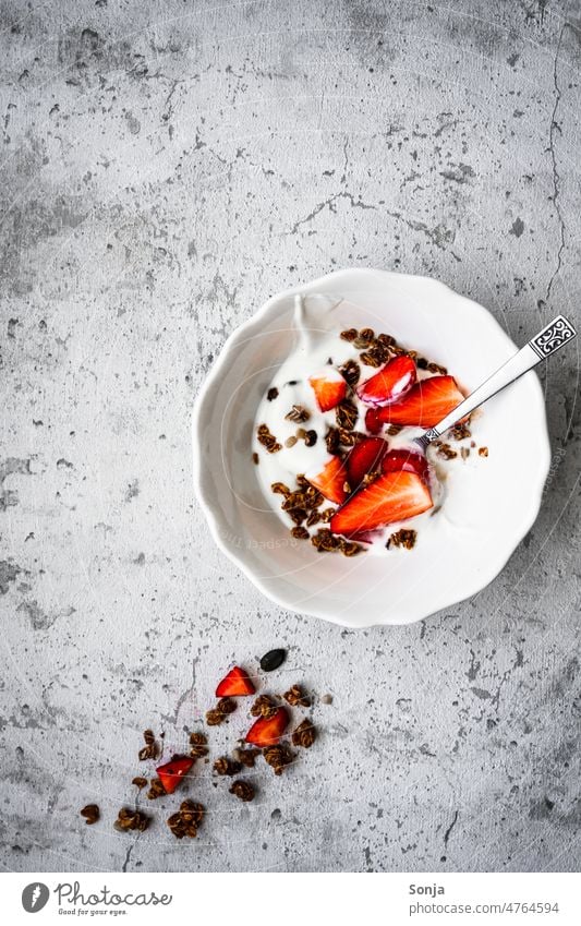 A cereal bowl with yogurt and fresh strawberries on a rustic table. Top view. Cereal Yoghurt Strawberry Breakfast Dessert Fruit Diet Organic Healthy White Dairy