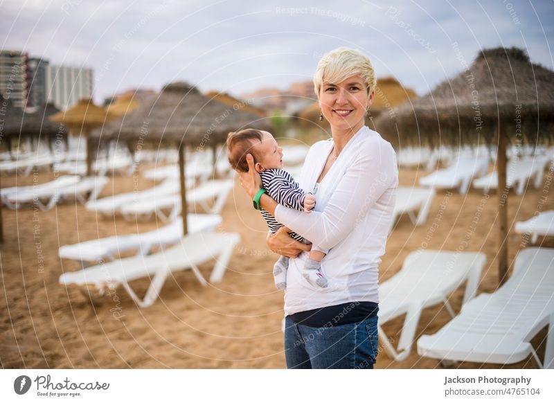 Mother with her newborn baby boy bonding at the beach in the resort by sunset kid mother portugal algarve rest two people mom parenthood young female portrait
