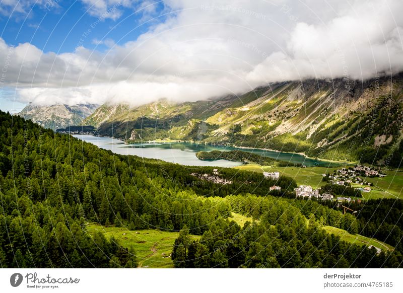 View to valley with lake with cloud in Engadin mountains Top of the mountain Mountaineering White Blue Freedom Clouds Cloud formation Hiking Deserted Nature