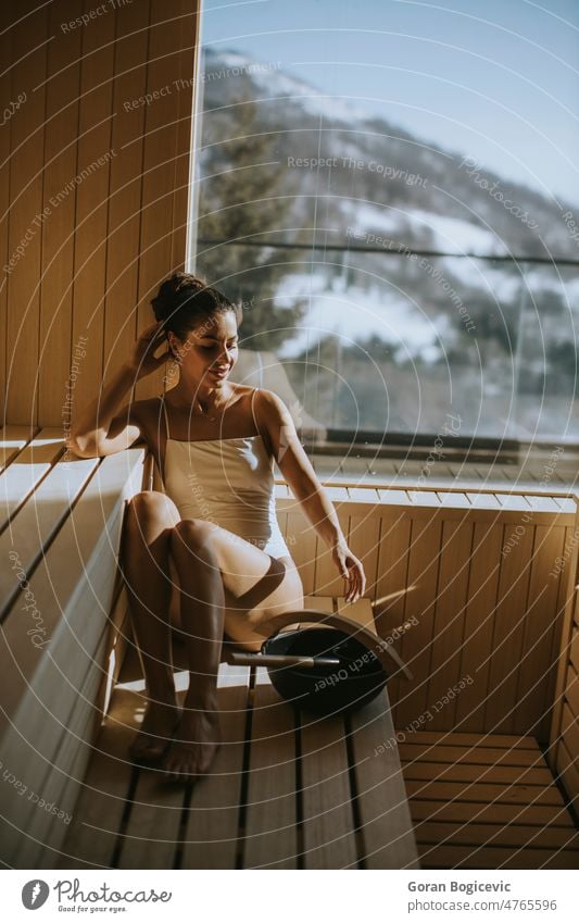 Young woman relaxing in the sauna activity adult attractive bath bathhouse beauty bench body caucasian comfortable cute enjoyment female health healthy heat