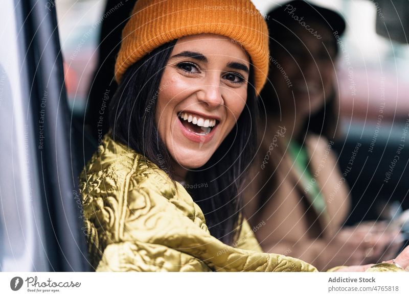 Smiling women sitting in car friend commute street city bonding spend time pastime leisure appearance feminine female cheerful glad positive smile content