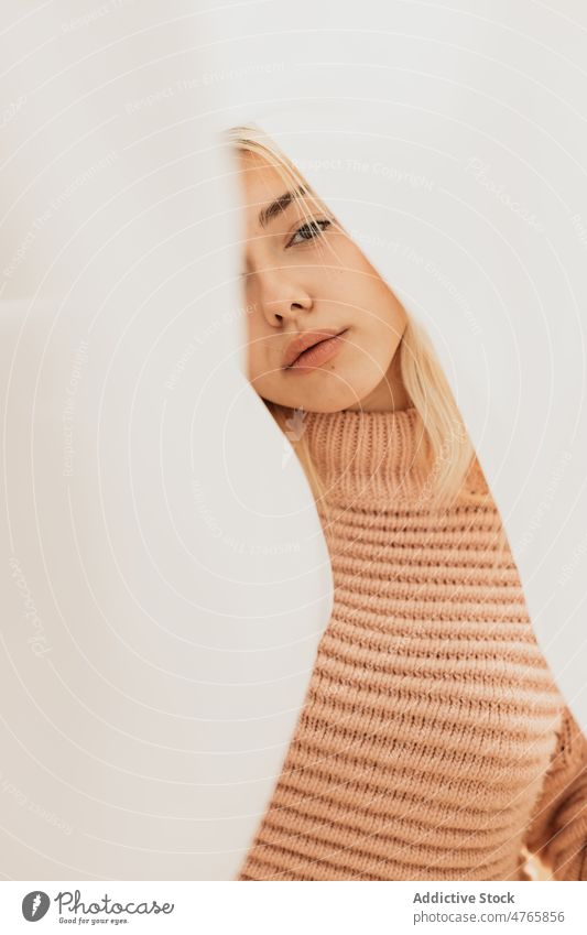 Blond female with white cloth woman cover face gentle idyllic sheet sweater dreamy portrait freedom posture posing individuality peaceful personality knitwear