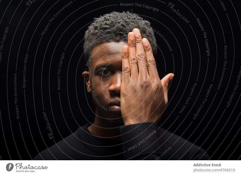 African American male model in studio man portrait cover face style ethnic curly hair guy half face black mental short hair african american haircut hairstyle
