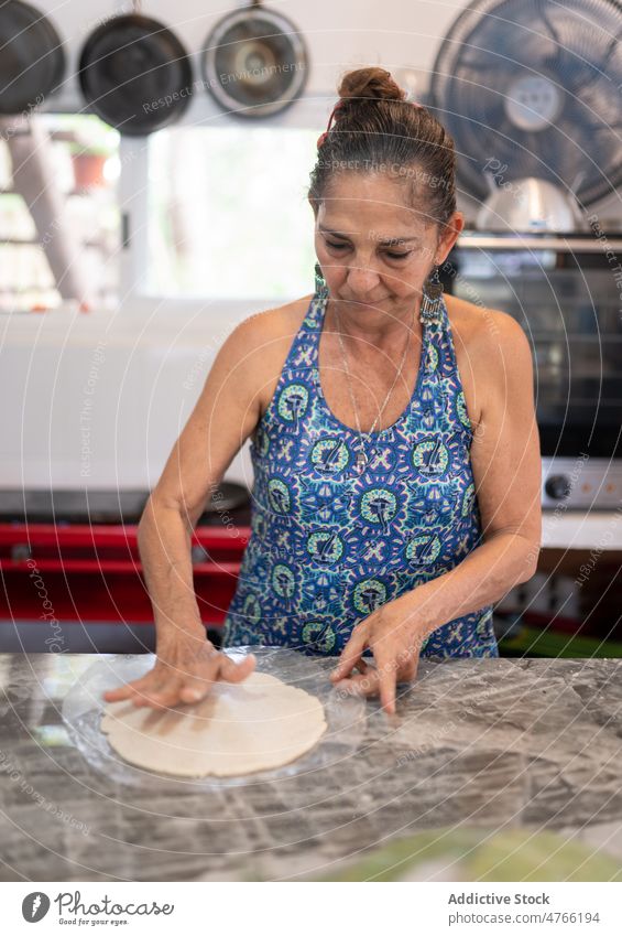 Mexican woman making dough for tortilla Mexican food raw kitchen cook culinary cafe cuisine work traditional mexican mixed race hispanic ethnic female fresh