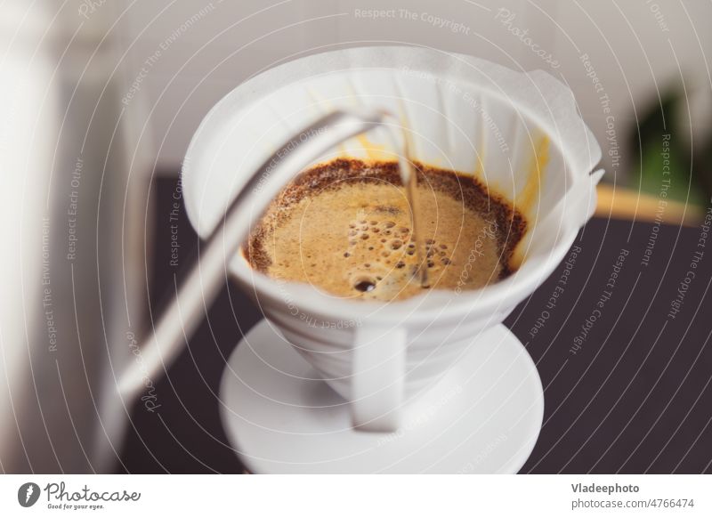 Barista pours boiling water brews ground coffee poured into a paper filter pouring barista hot pot electronic scale foam cup shop fresh art lifestyle liquid