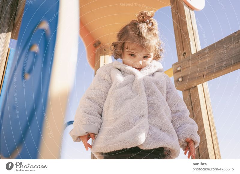 Little girl enjoying a sunny winter day at the playground toddler happy curious playful explore beach family adorable lovely childcare childhood emotion mood