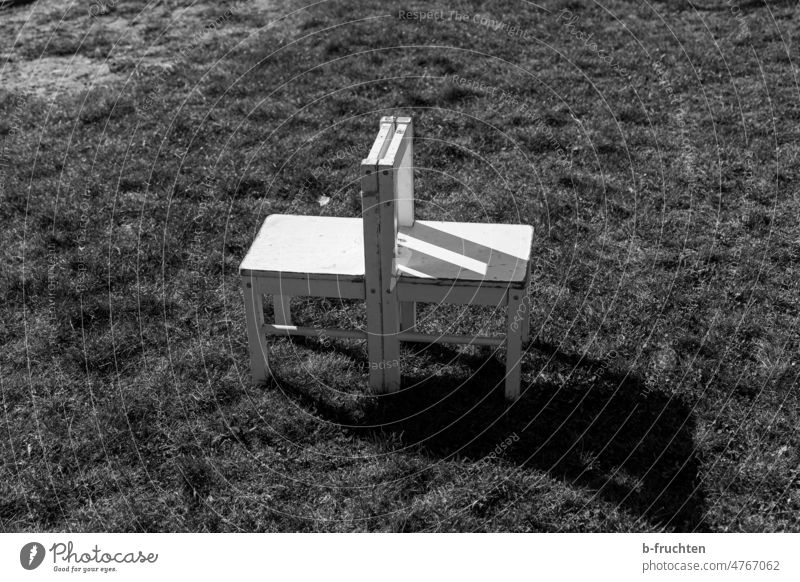 two white children chairs stand in the meadow White Chair Empty Seating Deserted Furniture Loneliness Places Free Seating capacity to each other Couple