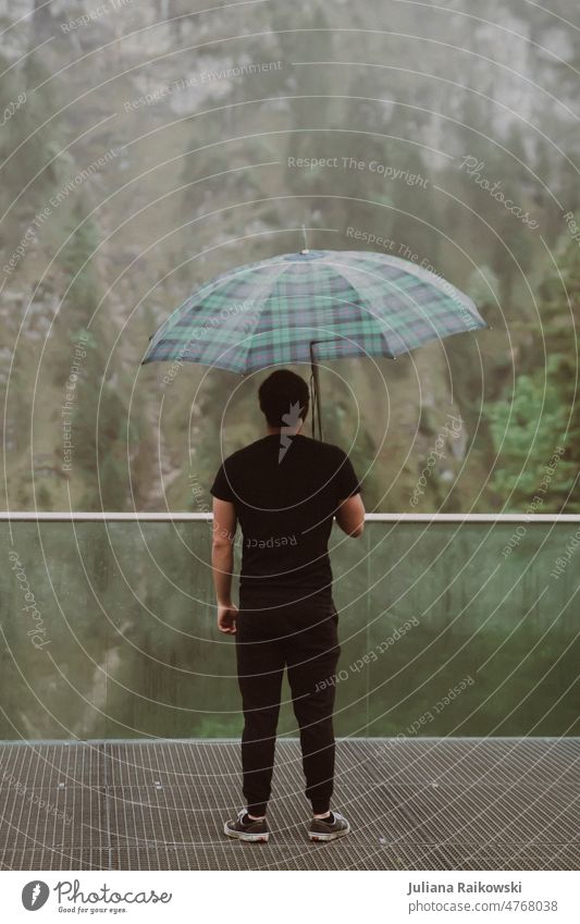 Man standing in rain with umbrella Umbrella Human being Rain Weather Bad weather Exterior shot Colour photo Day Wet Climate Umbrellas & Shades Protection Cold
