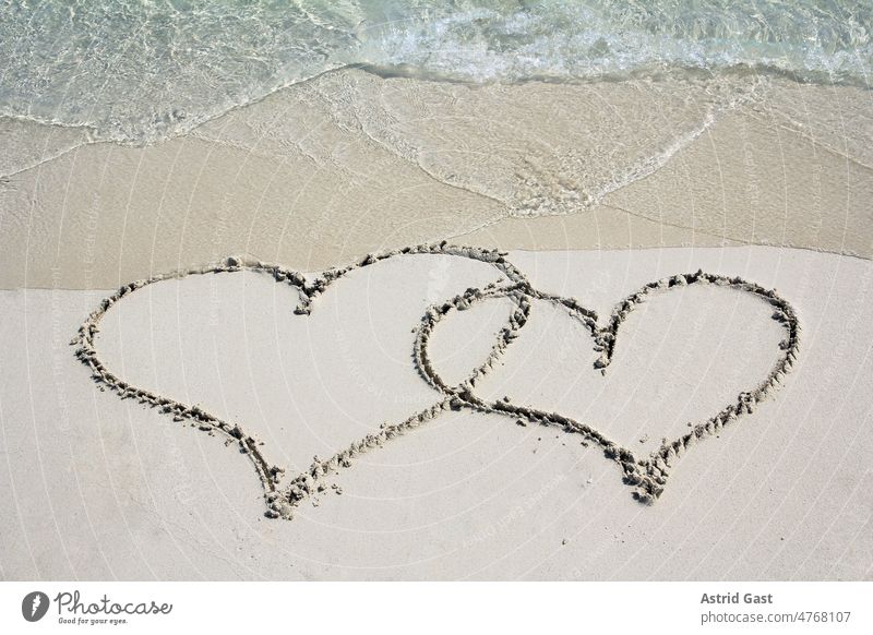 Two hearts in the sandy beach in front of the sea cuddle Beach Love vacation Sand Ocean Sandy beach Water wave holidays Relaxation free time bathe be afloat