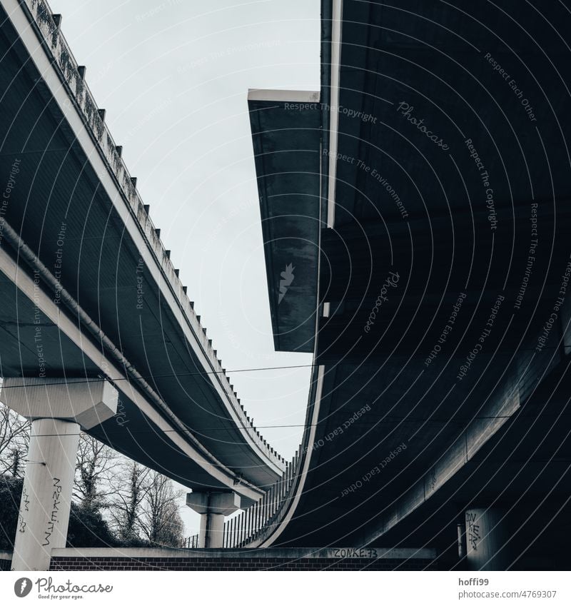 gloomy view of two intersecting elevated roads Overpass Street Concrete Modern architecture Concrete columns Street lighting diagonal Cloudless sky Twilight