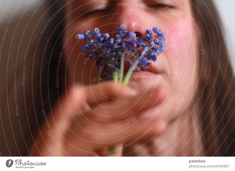 A woman enjoys the scent of meadow flowers with closed eyes Woman Fragrance sniff enjoyment sneeze Inhalation Wellness stop Nature Blossom purple Blossoming