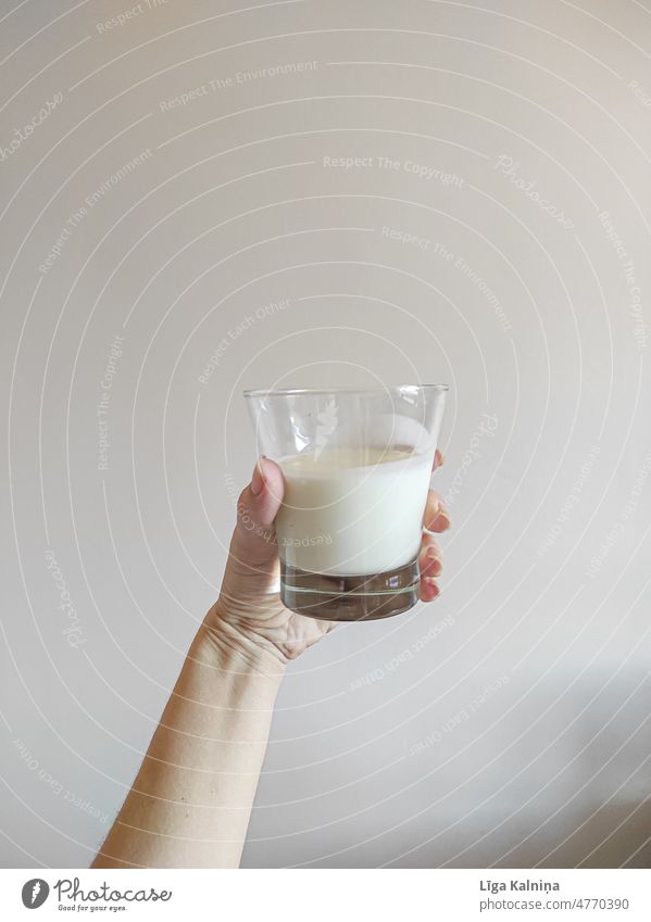 Hand holding a glass of kefir Kefir healthy drink White diet food Healthy Eating Diet Glass Cold drink Beverage Food photograph Fermentation Hold hand held