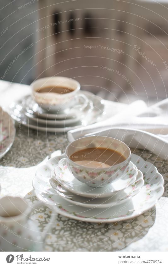 Table with a cups of coffee with fine germen porcelain romantic breacfast dishes white drinking beverage green table flowers pink home hot drink milk latte