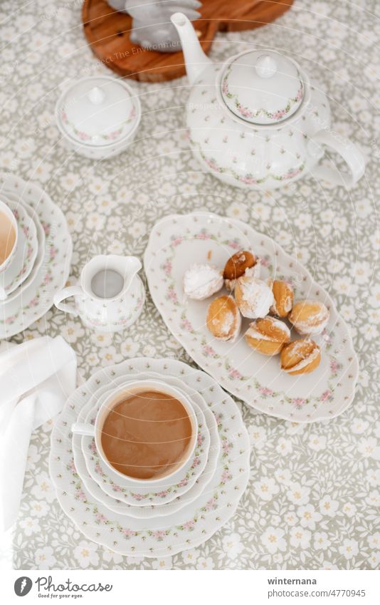 Beautiful table with fine porcelain, cookies, coffee flower green white pink teapot cup plate candy milk sugar sweets morning breakfast dessert brown beverage