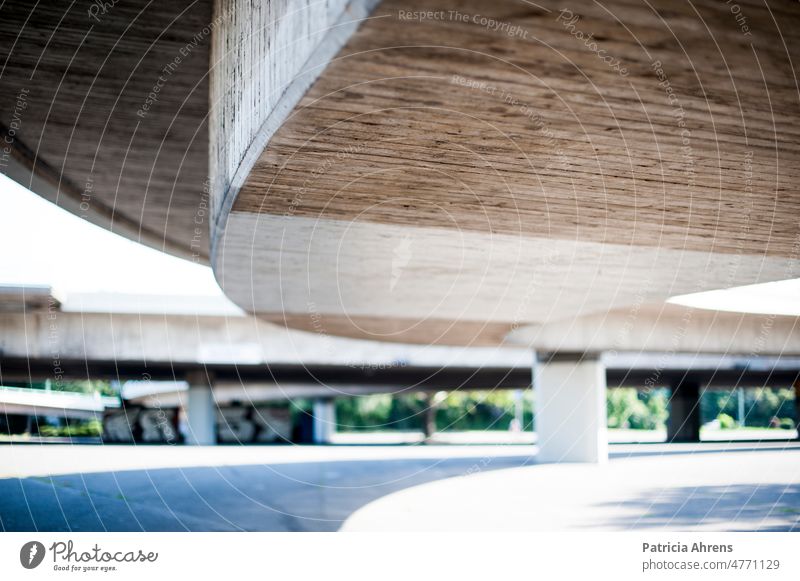 View under a concrete bridge, focus in foreground Bridge Concrete Concrete bridge Highway color Arch Curve Gray Gloomy dreariness Exterior shot Architecture