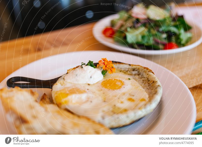 American tomorrow at the cafe. Fried eggs in a frying pan omelet vegetable healthy lunch meal scrambled yellow breakfast closeup delicious dish food fresh fried