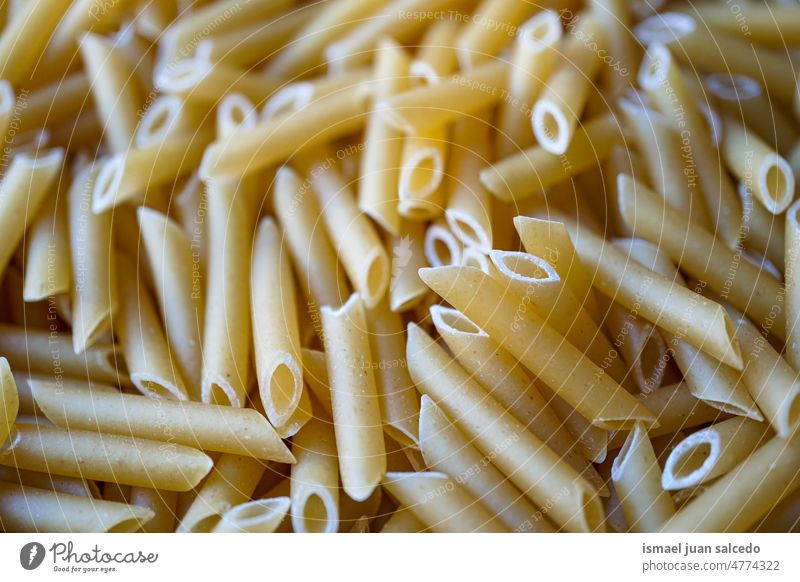 uncooked macaroni pasta, italian food raw penne yellow meal ingredient cooking healthy dry italy dinner spaghetti eating cuisine noodle close-up closeup flour