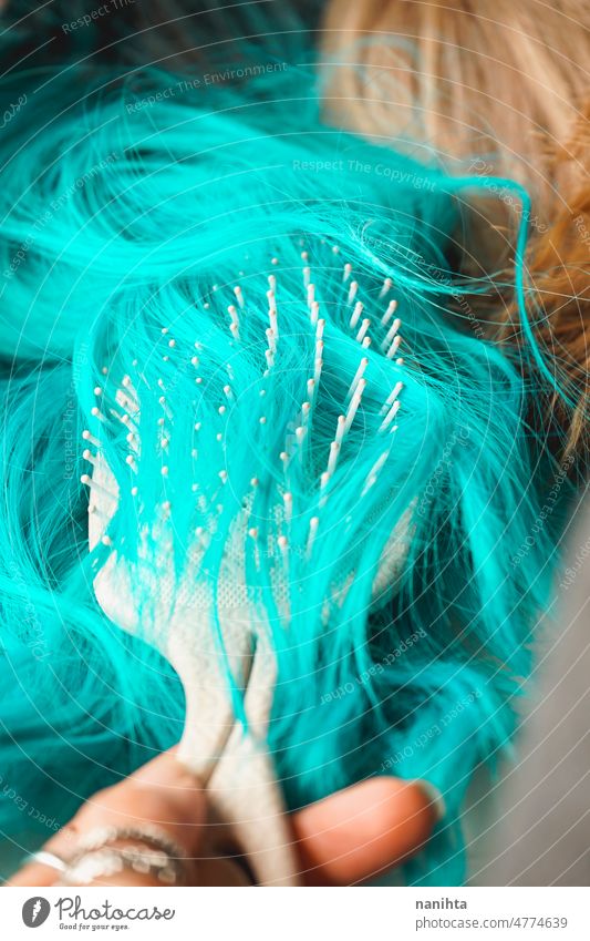 Close up of a brush brushing a colored wig hair style hairdressed stylize texture soft smooth close close up macro cosplay knot fragile fragility vulnerability