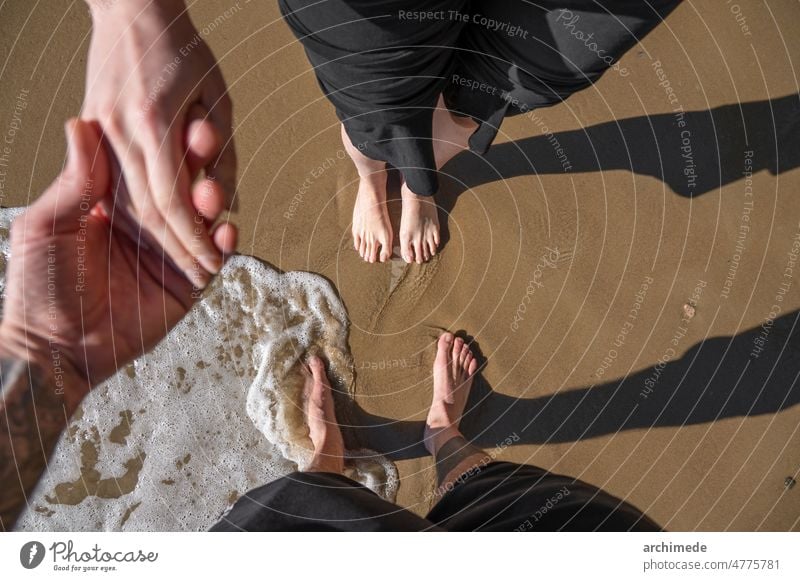 Couple together at beach hand in hand adventure anonymous barefeet boyfriend couple enjoy explore foot girlfriend hold holding hands holiday leisure lifestyle