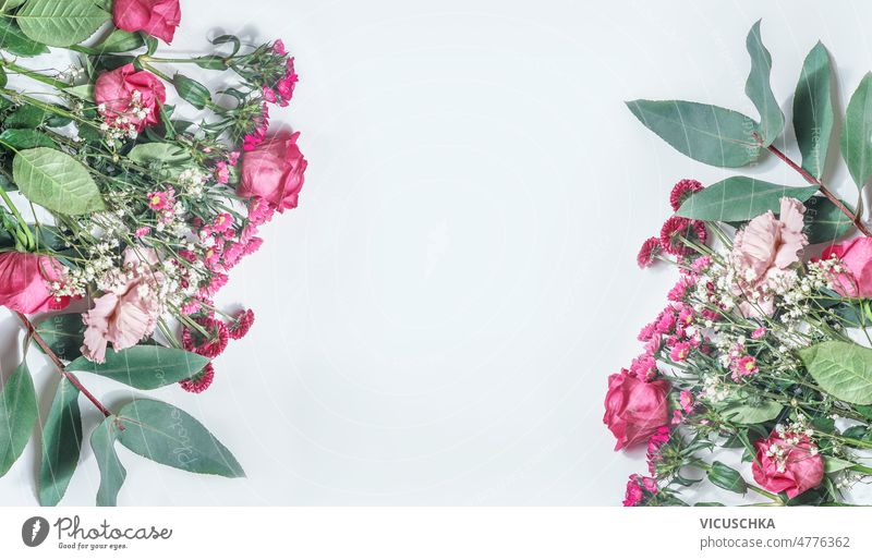 Romantic flower bouquets frame with pink and white flowers, roses and green leaves at white white background beautiful blooming floral arrangement copy space