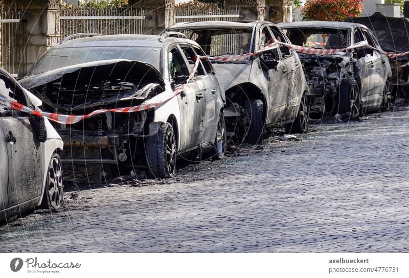 burnt out car wrecks in residential street after vandalism in Germany burned germany arson gutted city destruction crime vehicle automobile transportation fire