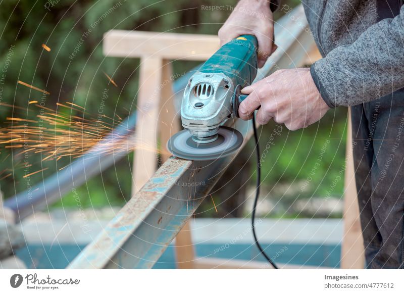 A man working on a steel beam with an electric grinding tool, angle grinder. Sparks fly. Electric grinding. Remove rust more adult Angle grinder Blade