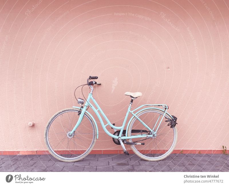 World Bike Day / A pale blue bicycle parked in front of a pink wall Bicycle Cycling Leisure and hobbies Mobility Wheel leeze fietse Eco-friendly In transit