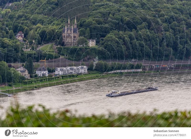 Aerial view of St. Apollinaris church surrounded by forest, in front of Rhine river with boat, Remagen, Germany Rhein valley Culture Europe Bonn German culture