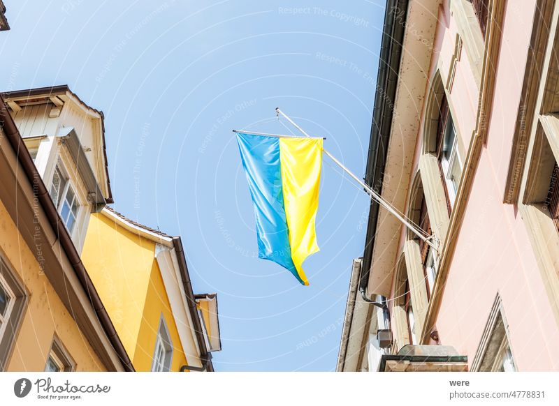A Ukrainian flag hangs on a house in the old town of Lindau as a sign of solidarity Russia bavaria blue building copy space german historic nobody