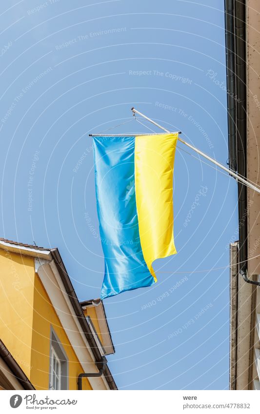 A Ukrainian flag hangs on a house in the old town of Lindau as a sign of solidarity Russia bavaria blue building copy space german historic nobody