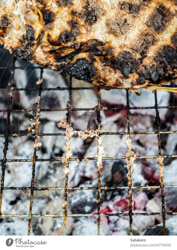 Skin of fish grilled on hot charcoal until black and scorched food background delicious meat roasted meal healthy tasty gourmet eating lunch stove skin cooking