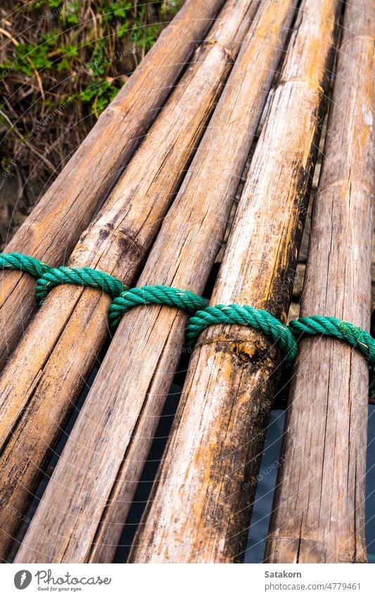 Dried bamboo tie with green nylon rope dry natural bridge nature tropical forest outdoor wood wooden asia way closeup old material plant view garden countryside