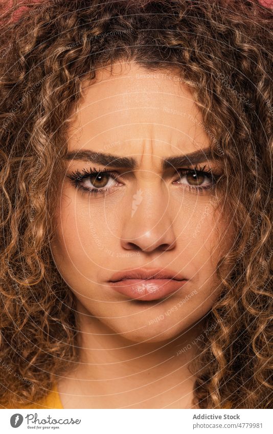 Young woman with bright makeup looking at camera curly hair appearance sad portrait frustrated serious ginger pissed off young style charming human face