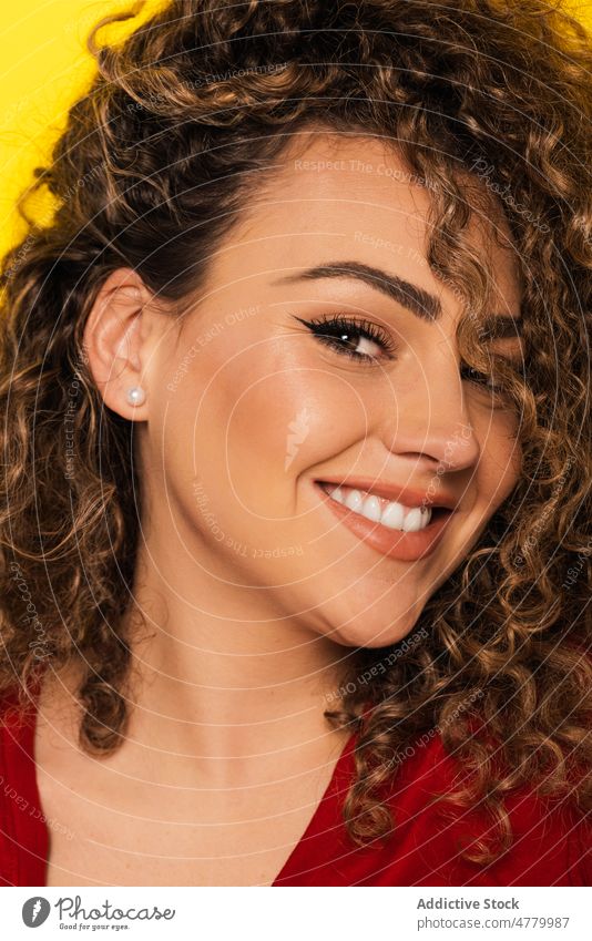 Gorgeous blonde woman with curly hair in studio smile cheerful happy positive optimist young appearance casual style glad bright joy portrait colorful