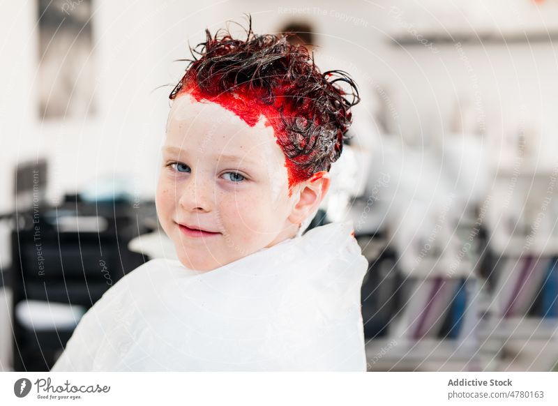 Boy with dyed red hair boy kid salon childhood portrait dyed hair rebel appearance hairstyle informal client trendy light adorable cute modern glad optimist
