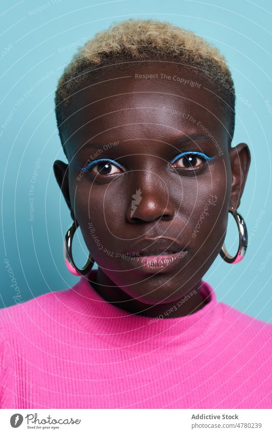 Close up of serene African woman with short hair style dyed hair feminine trendy fashion hairstyle appearance female african studio charming vivid colorful